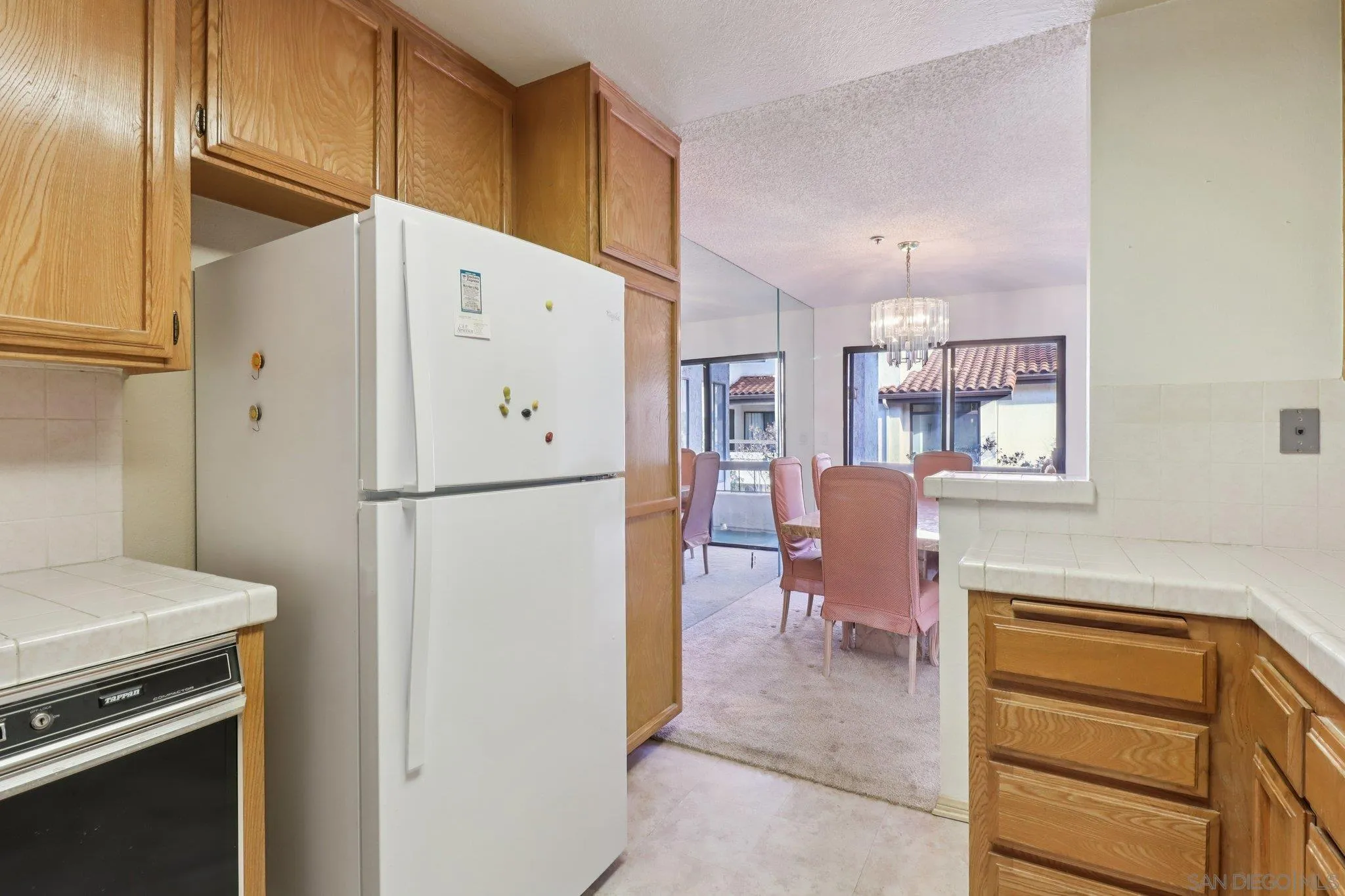 5645 Friars Road, Unit 386 San Diego, CA 92110 - Photo 27 of 72 a kitchen with stainless steel appliances a refrigerator and a stove