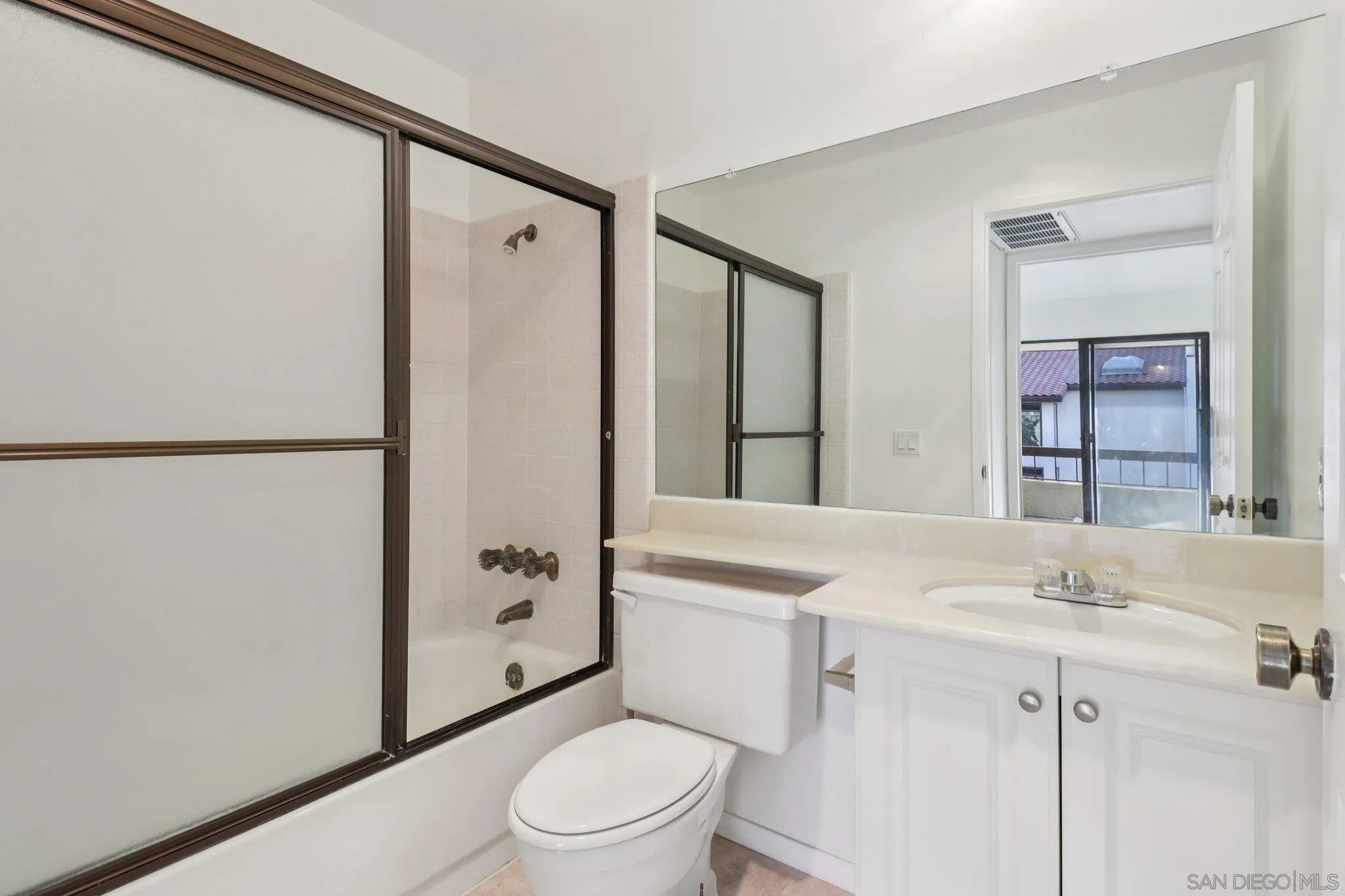5645 Friars Road, Unit 386 San Diego, CA 92110 - Photo 31 of 72 a bathroom with a sink a mirror toilet and shower