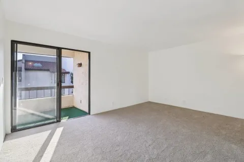 a bedroom with bed a couch and painting on the wall