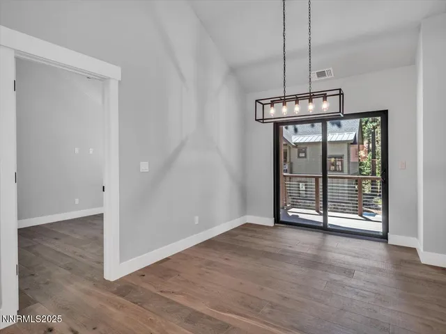 a large kitchen with stainless steel appliances a sink and a refrigerator
