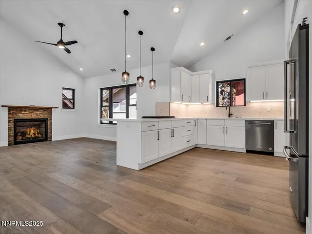 a front view of a building with a garden and trees