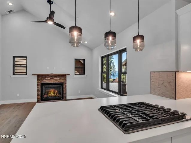 a view of a lush green field with mountains in the background