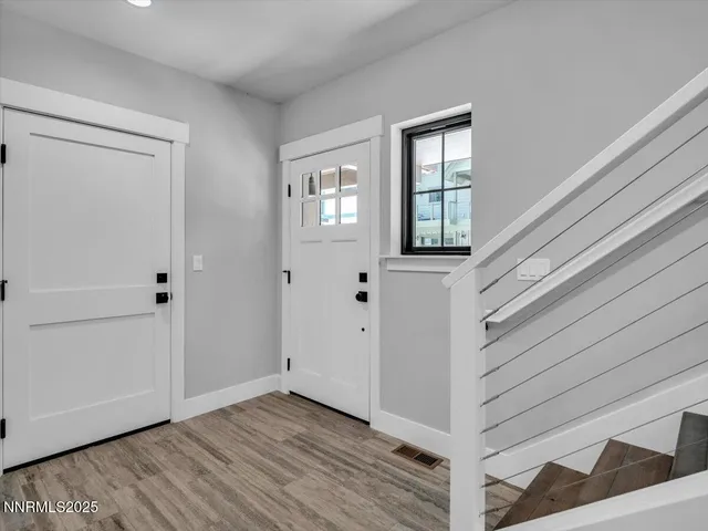 a view of wooden floor and windows in a room