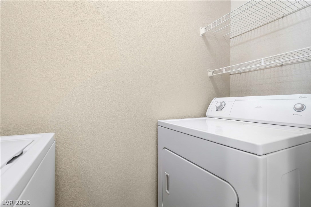 10550 West Alexander Road, Unit 2060 Las Vegas, NV 89129 - Photo 22 of 45 Functional laundry space featuring convenient shelving and essential appliances.