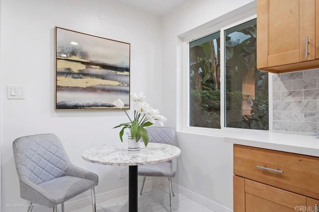 a view of a dining room with furniture and window