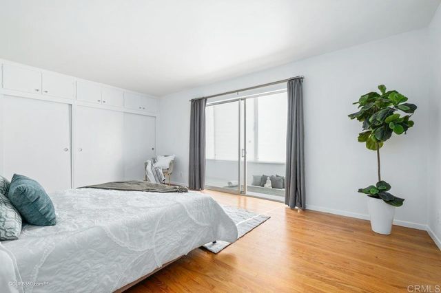 a bedroom with a bed potted plant with the window