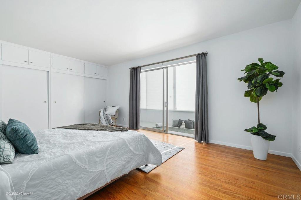 2352 Torrey Pines Road, Unit 1 La Jolla, CA 92037 - Photo 16 of 37 a bedroom with a bed potted plant with the window