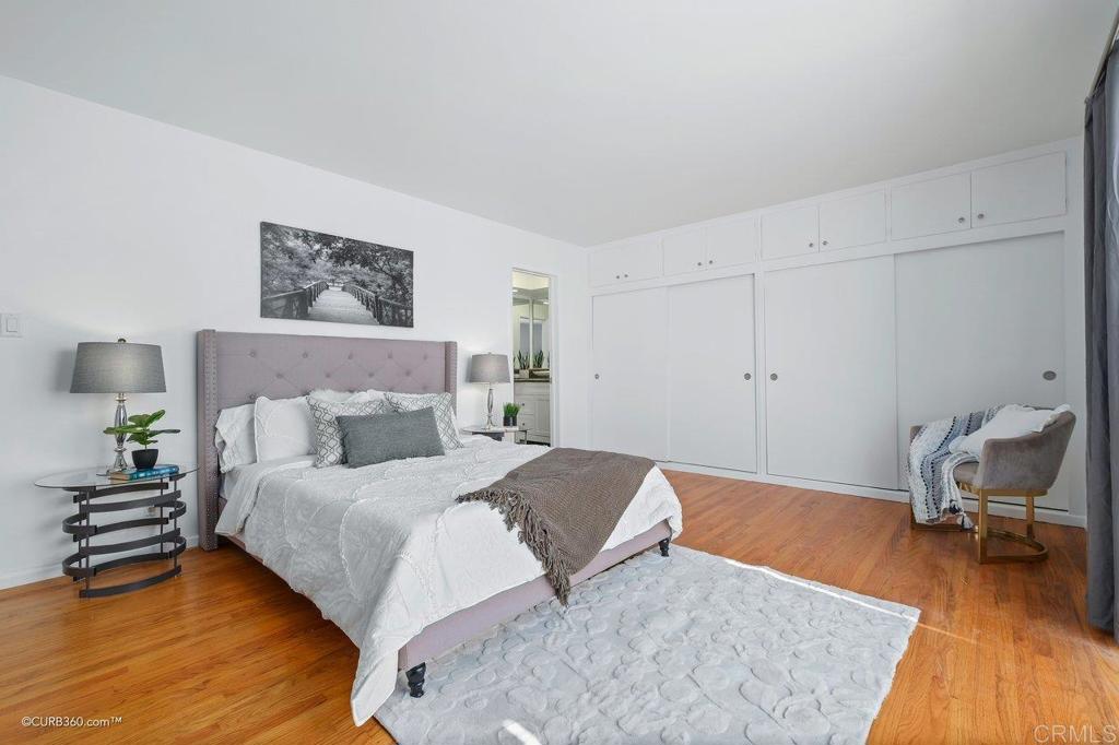 2352 Torrey Pines Road, Unit 1 La Jolla, CA 92037 - Photo 17 of 37 a bedroom with a bed and wooden floor