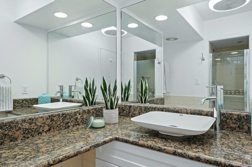 2352 Torrey Pines Road, Unit 1 La Jolla, CA 92037 - Photo 18 of 37 a room with a granite countertop sink and a mirror