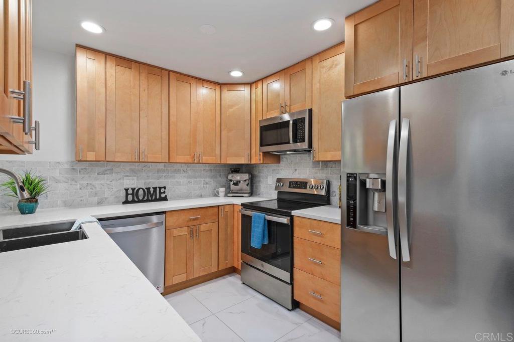 2352 Torrey Pines Road, Unit 1 La Jolla, CA 92037 - Photo 2 of 37 a kitchen with stainless steel appliances granite countertop a refrigerator sink and microwave