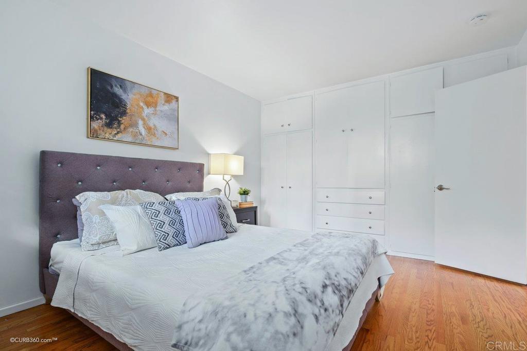 2352 Torrey Pines Road, Unit 1 La Jolla, CA 92037 - Photo 21 of 37 a large bed sitting in a bedroom and painting on the wall