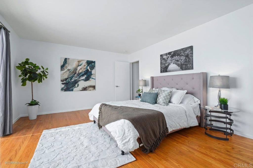 2352 Torrey Pines Road, Unit 1 La Jolla, CA 92037 - Photo 24 of 37 a bedroom with a bed painting on wall and a potted plant