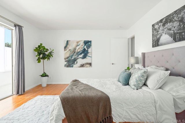 a bedroom with a bed and a painting on the wall