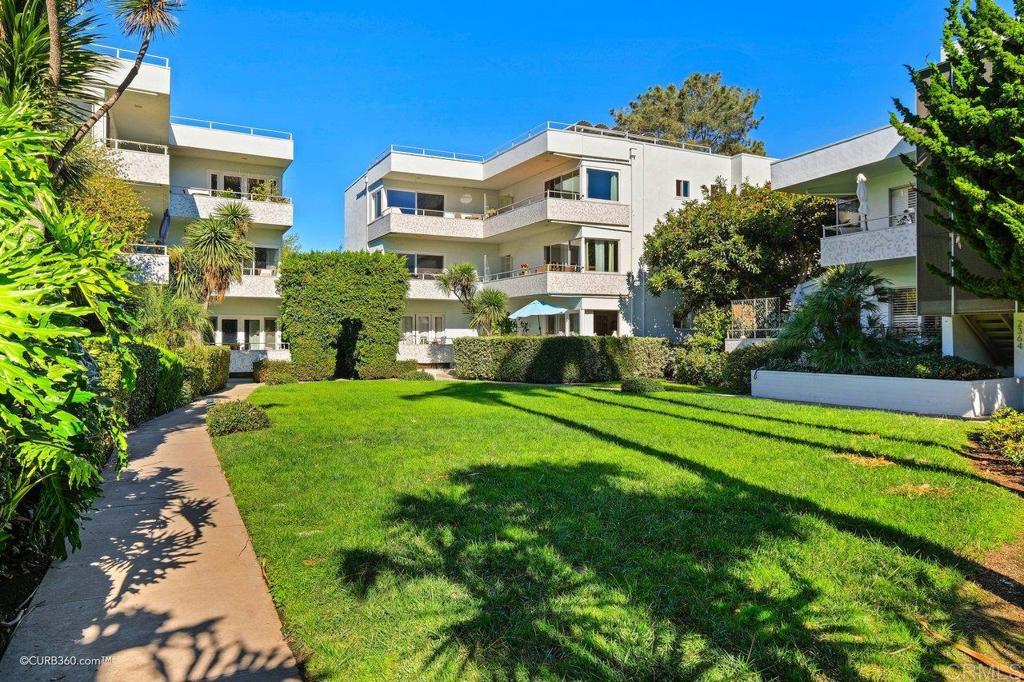 2352 Torrey Pines Road, Unit 1 La Jolla, CA 92037 - Photo 27 of 37 a front view of a house with a yard table and chairs