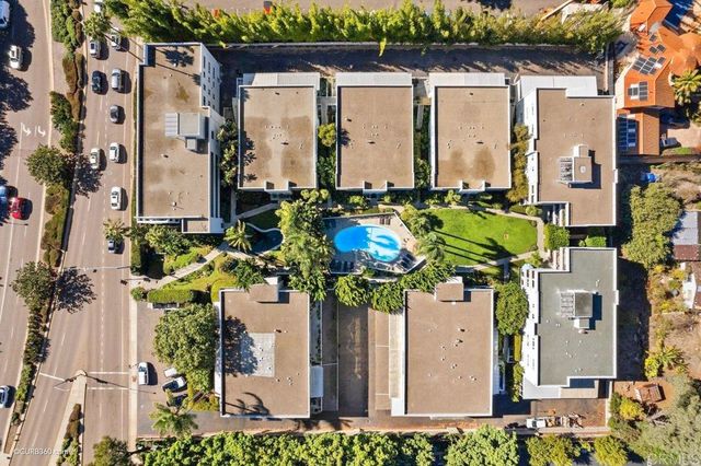 an aerial view of a house with a yard and plants