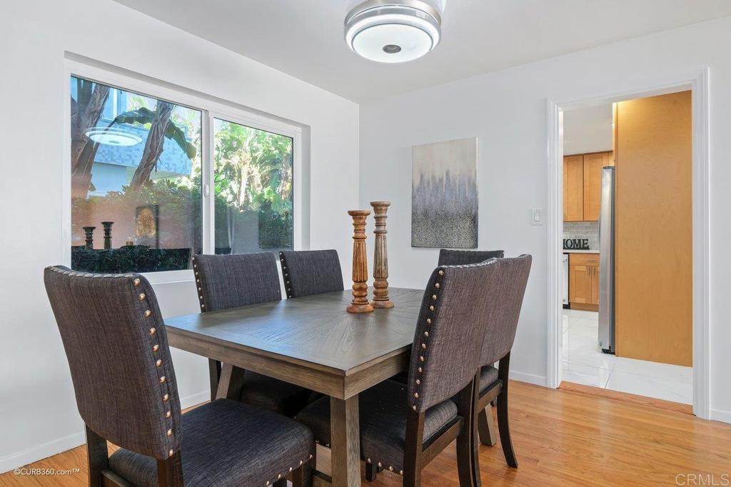 2352 Torrey Pines Road, Unit 1 La Jolla, CA 92037 - Photo 8 of 37 a view of a dining room with furniture window and wooden floor