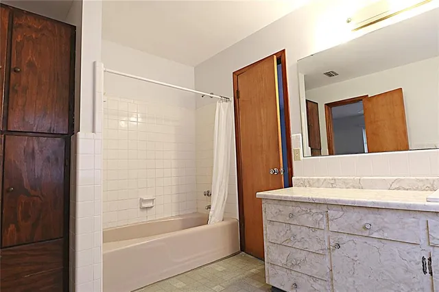 a bathroom with a bathtub and a sink