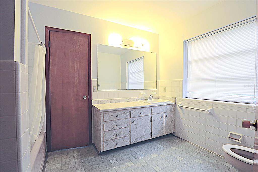 1000 Cody Cove Road Babson Park, FL 33827 - Photo 10 of 16 a bathroom with a granite countertop sink mirror and a