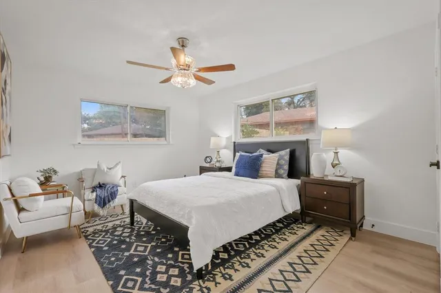 a bedroom with a bed and a chandelier