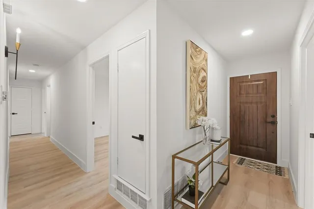 a view of an entryway with wooden floor