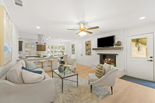 a living room with furniture a fireplace and a flat screen tv
