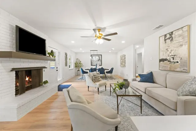 a living room with furniture a fireplace and a flat screen tv