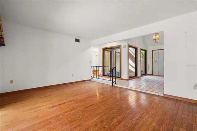 a large white kitchen with a sink a refrigerator and a stove