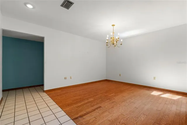 a view of an empty room with a fireplace and a window