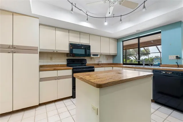an empty room with windows and ceiling fan view