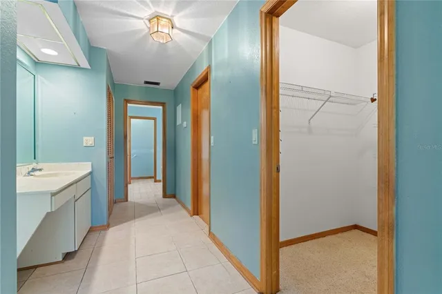 an aerial view of a house with a garden and lake view