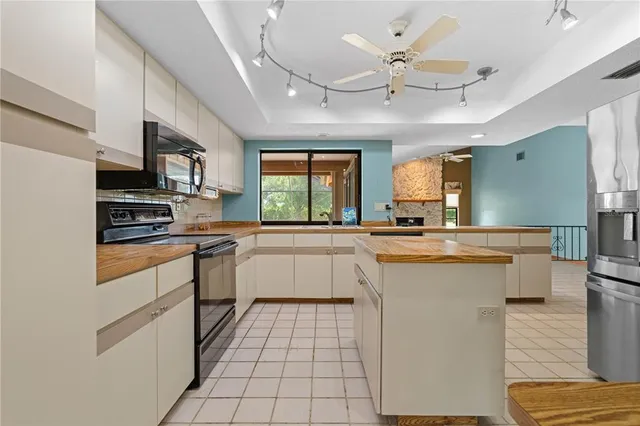 a large white kitchen with a large window
