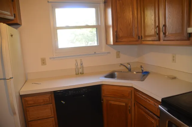 a kitchen with a sink cabinets and a window