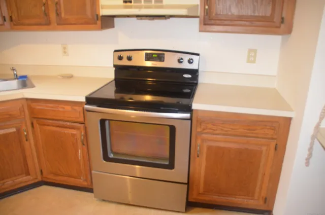 a stove top oven sitting inside of a kitchen