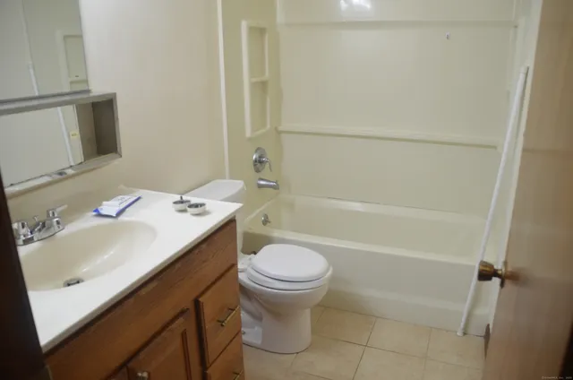a bathroom with a sink toilet vanity and tub