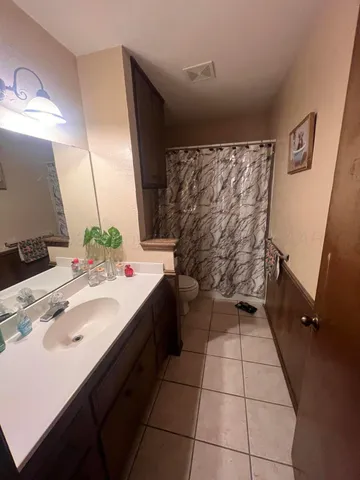 a bed sitting in a bedroom and lamp