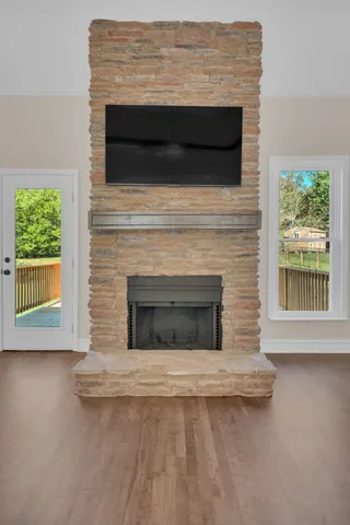 a living room with a fireplace and a flat screen tv