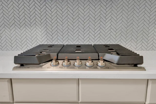 a kitchen with a sink and a stove top oven