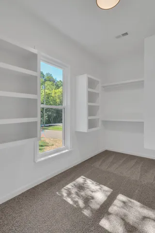 a view of an empty room with a window