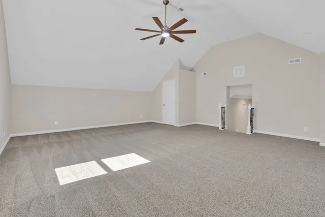 an empty room with closet and fan