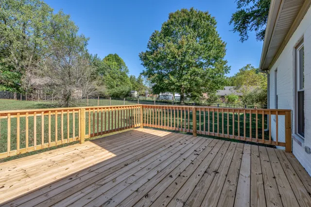 a balcony with wooden floor and fence