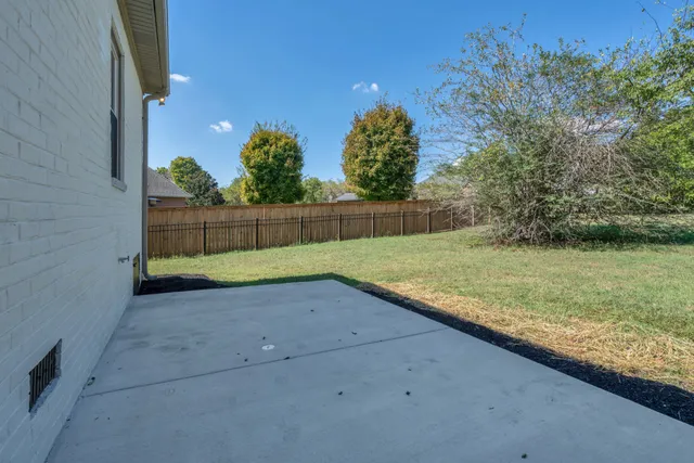 a view of backyard with deck and furniture