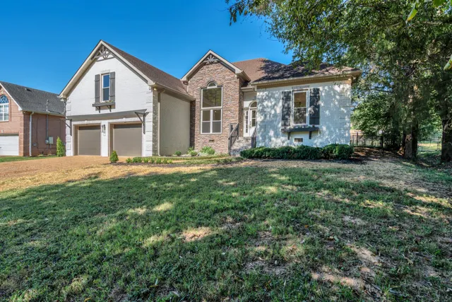 a front view of a house with a garden