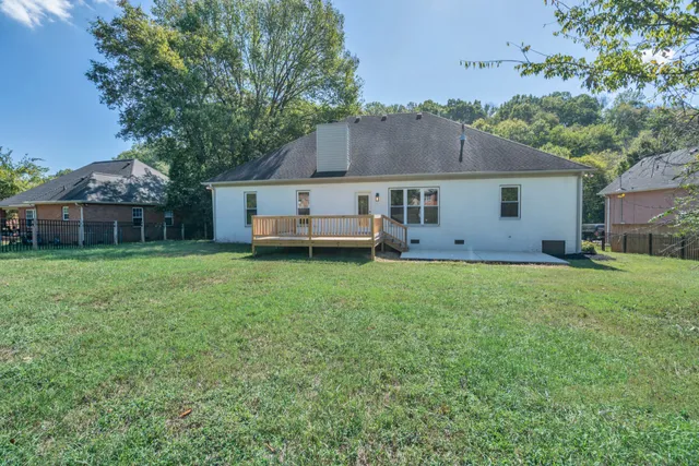 a backyard of a house with garden and deck