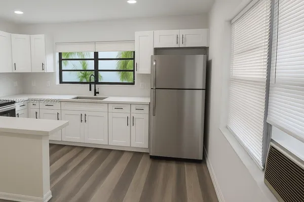 a kitchen with a refrigerator sink and cabinets