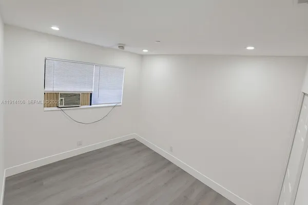 a view of a room with wooden floor and sink