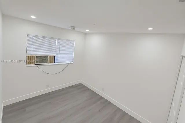 a view of a room with wooden floor and sink