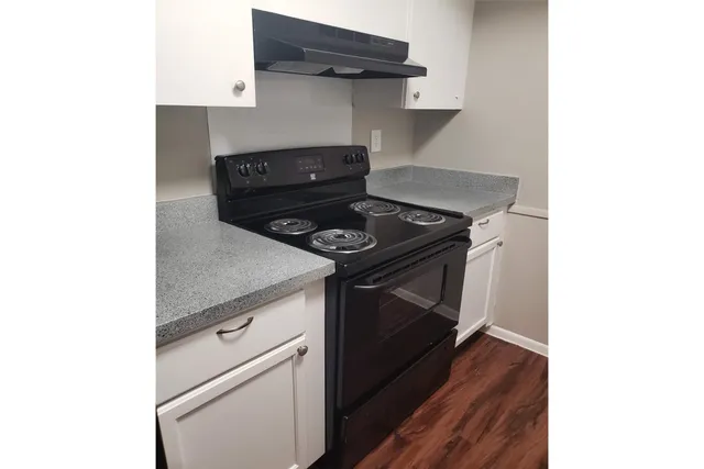 a kitchen with a stove and a microwave