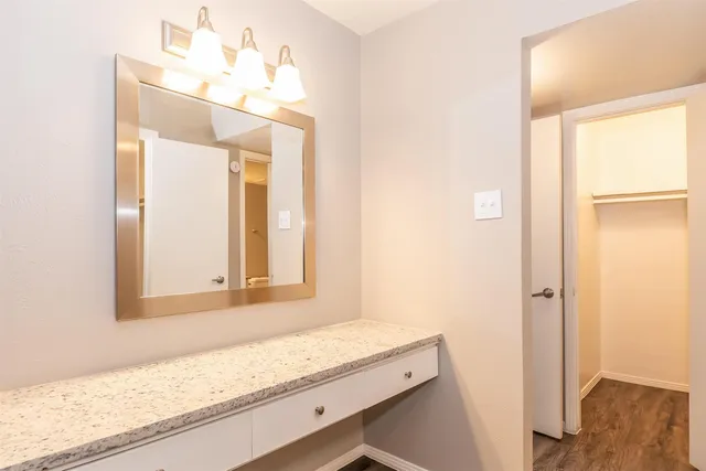 a bathroom with a granite countertop sink and a mirror
