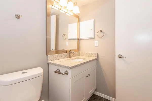 a bathroom with a sink a toilet and vanity