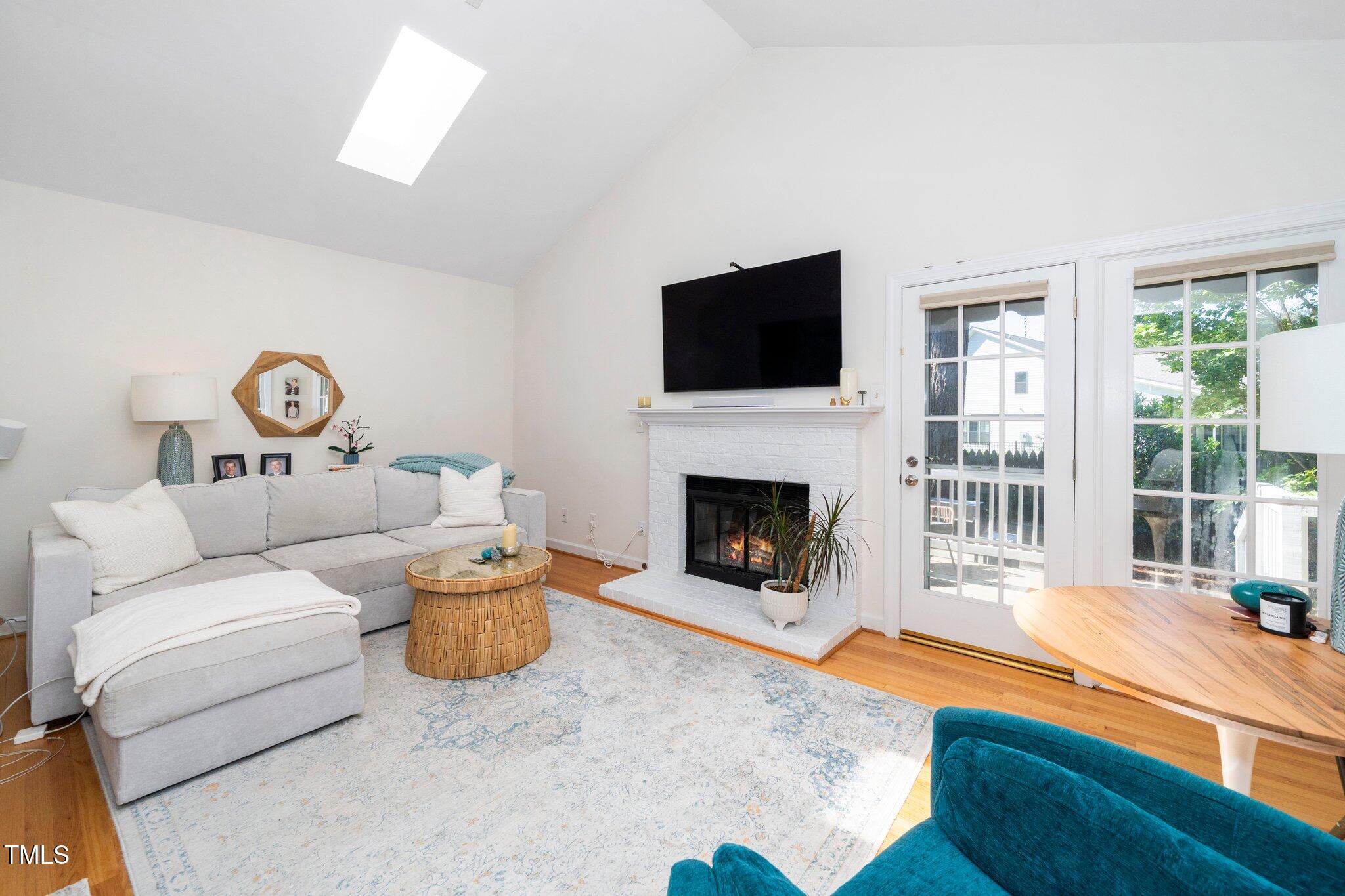 1712 Briarforest Place Raleigh, NC 27615 - Photo 15 of 55 Vaulted ceiling with skylight and lots of windows provides great natural light in the family room.